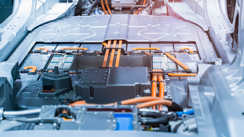 floor of an electric car with visible battery pack and orange cables floor of an electric car with visible battery pack and orange cables